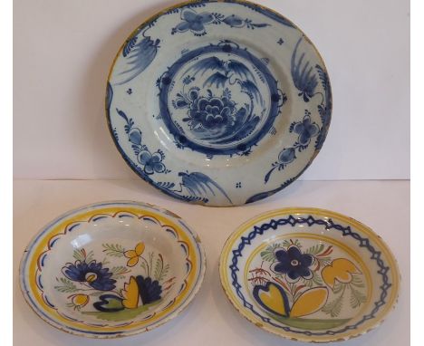 An 18th century Delftware dish typically decorated in underglaze blue with flowers and leaves etc., applied seal mark of Duve