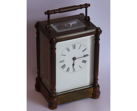 A late 19th century brass and glass-sided carriage clock with key, the white-enamel dial with Roman numerals (14cm high)&nbsp