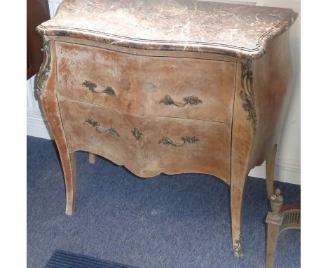 A serpentine-fronted marble-topped Louis XV style petite commode of bombe shape, two frieze drawers with foliate cast handles