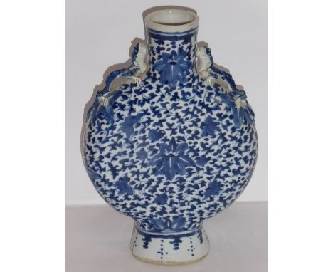 A 19th century Chinese porcelain moon flask hand-decorated in under-glaze blue with scrolling lotus, the neck flanked by two 