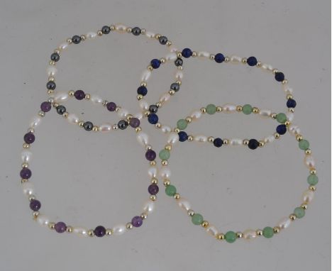 A set of four baroque seed pearl and semi precious stone bracelets featuring amethyst, lapis lazuli,hematite.