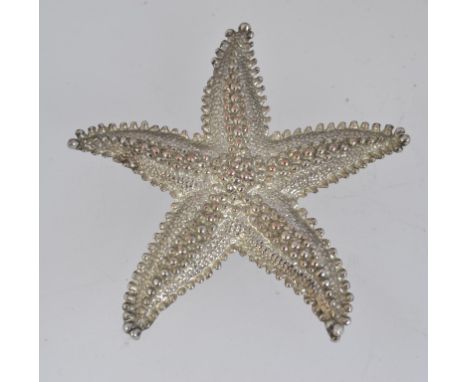 A large vintage white metal brooch pin in the form of a starfish with roller clip clasp. Measures. 6.5cms