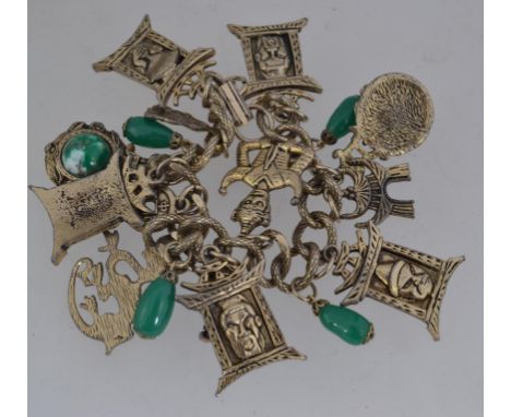 A vintage yellow metal charm bracelet with chinese style charms including dragon pagoda with jade style drops  on a snake ski