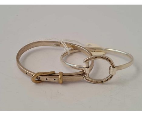 A silver horse shoe bracelet and buckle bracelet example