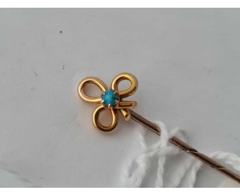 A gold turquoise clover leaf stick pin