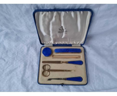 An attractive silver gilt and enamel manicure items including jar and cover, nail buffer etc, Birmingham 1932