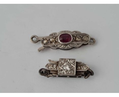 Two platinum and white gold clasps with ruby and diamond