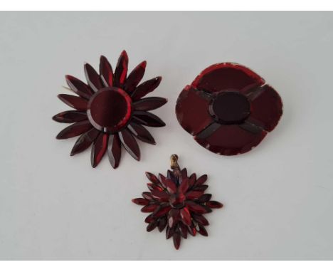 Two early Victorian red Vauxhall glass brooches and a pendant
