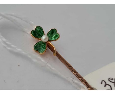 A gold and enamel and pearl clover leaf stick pin