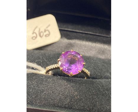 A circular amethyst ring 9ct size N