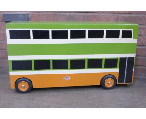 A large painted wooden model of a bus, 76cm long 