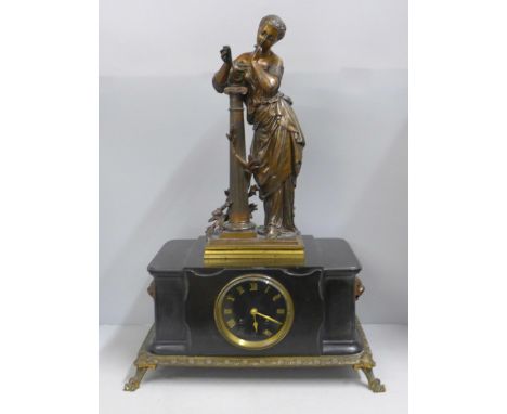 A 19th Century French belge-noir mantel clock on a cast metal frame with patinated bronze sculpture of a maiden leaning again