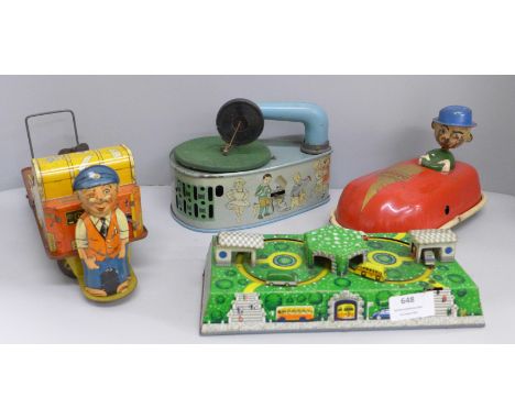 Four tin-plate toys, Codeg clockwork car, clockwork luggage trolley, made in Gt. Britain, record player and car diorama 