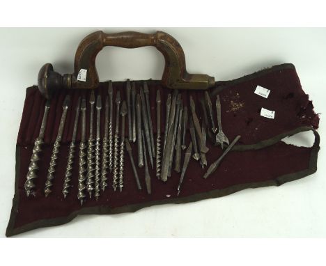An early Moulson of Sheffield brace hand drill and a roll of related bits, the brace with brass mounts on wooden handle, 35cm