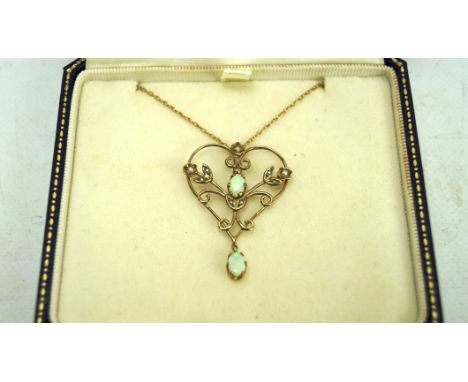 An Edwardian 9ct gold and opal pendant, on a 9ct gold chain, combined weight 3.2g