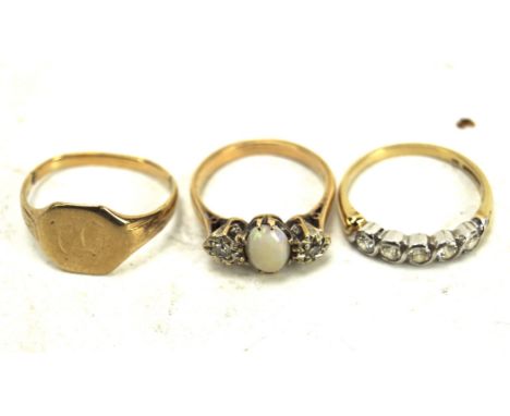 Three 9ct gold and yellow metal rings, including a signet ring, a three stone diamond and opal ring, five stone ring and more