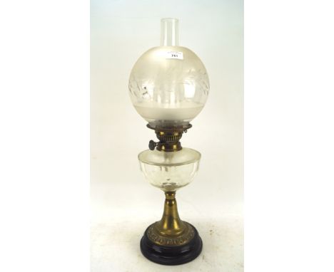 A 19th century oil lamp, the brass structure mounted on a circular ceramic base, with a clear glass reservoir and shade decor