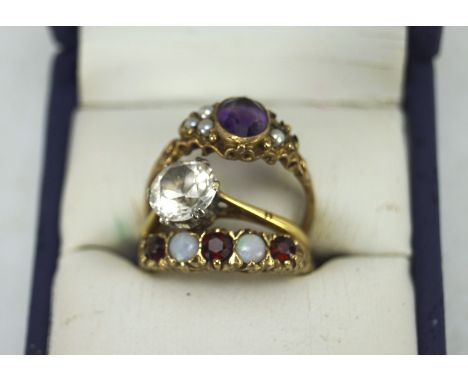 9ct gold opal and garnet set dress ring, an 18ct gold solitaire ring set white stone and a 9ct gold amethyst and seed pearl d