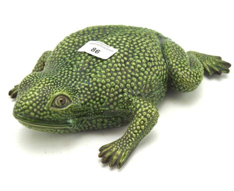 A 20th century Portugese ceramic figure of a Toad, indistinctly marked to base, 27cm long Condition Report: One part of the f