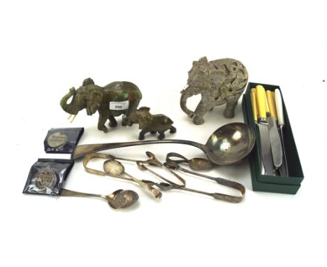 Assorted collectables, to include a three stone elephants, a £5 coin, silver plated ladle, butter knives and more