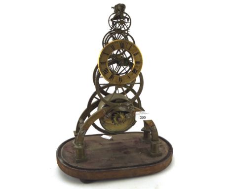 A late 19th century part skeleton clock with Roman numerals denoting hours, fixed on an oval wooden base, marked R. Webster, 
