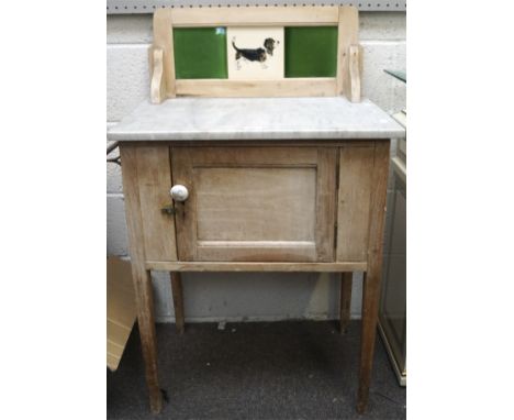 A late 19th/early 20th century pine marble topped wash stand, the top mounted with three framed ceramic tiles, 102cm x 61cm x