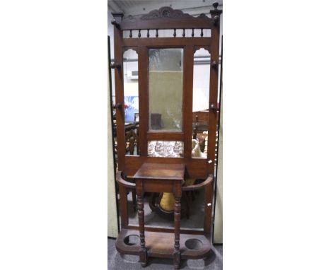 An Edwardian coat stick stand, with mirrored back and six coat pegs, above a central glove box, 199cm x 80cm wide