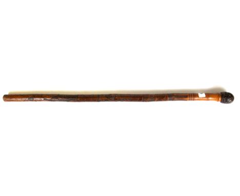 An early 20th century Japanese carved bamboo walking stick, L. 78cm.