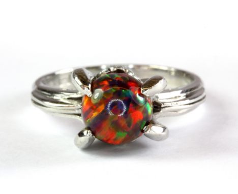 A platinum (stamped 850) ring set with a cabochon cut black opal (J.5).