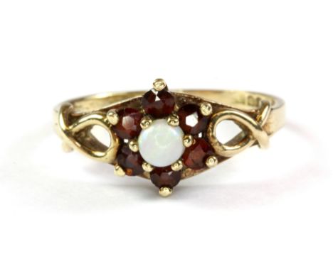 A yellow metal (tested 9ct yellow gold) garnet and opal cluster ring, (N.5).