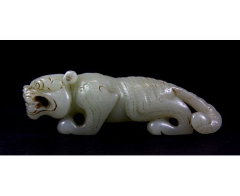 An early 20th century Chinese carved nephrite jade model of a tiger, L. 9cm.