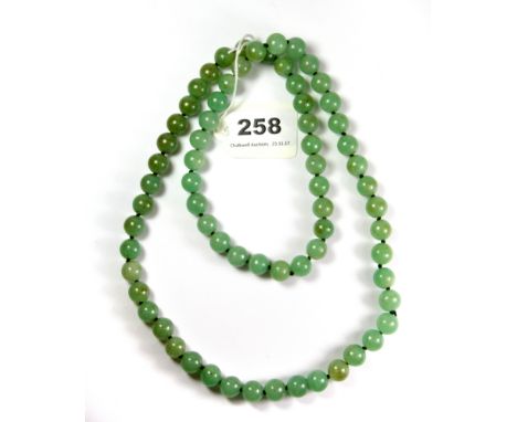 A single strand jade bead necklace.