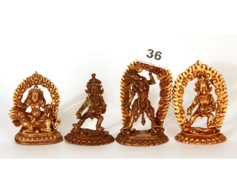 Four small very detailed Tibetan gilt bronze figures of Buddhist Deities, tallest H. 9cm.