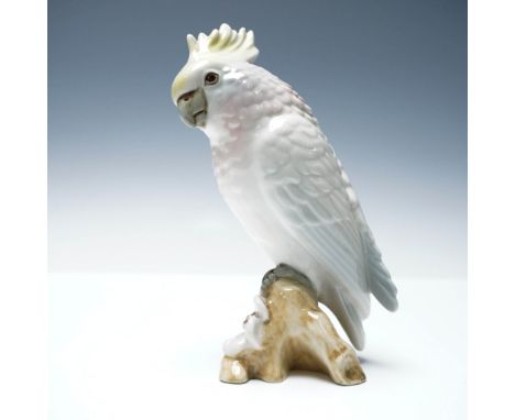 Delicately crafted porcelain figurine by Royal Dux, featuring a lifelike cockatoo perched gracefully on a gnarled tree branch