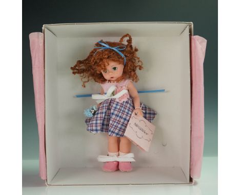 This delightful Madame Alexander doll, named "Pretty in Pink and Blue," is a perfect showcase of playful charm and meticulous