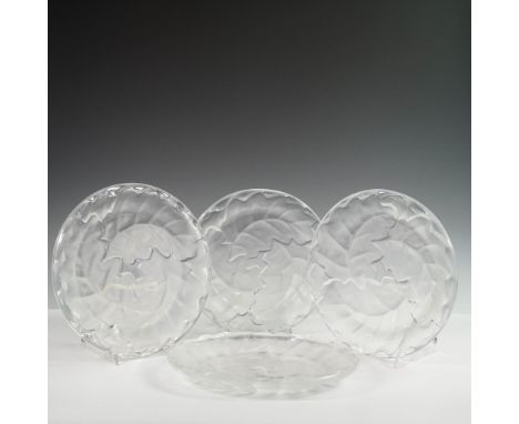 A set of four Lalique crystal plates in the classic Chene pattern, featuring an oak leaf design. Theehese round plates showca