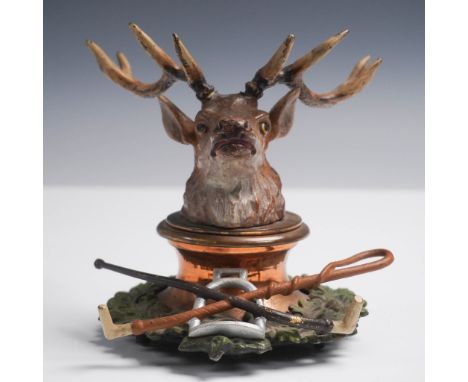 Unusual figural inkwell featuring a detailed stag head that lifts to reveal a copper-lined inkwell beneath. The hinged lid is