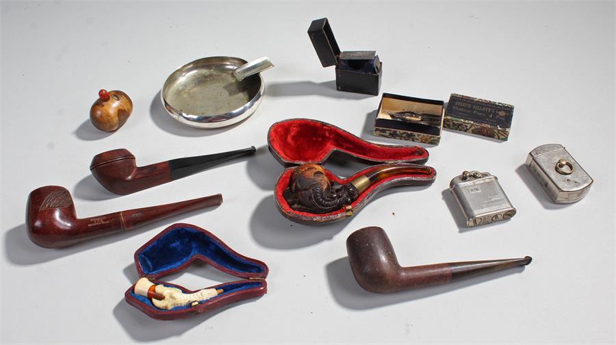 A collection of pipes and smoking paraphernalia to include two vintage