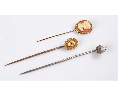 Three stick pins, to include a cameo example, a yellow metal example and another , (3)