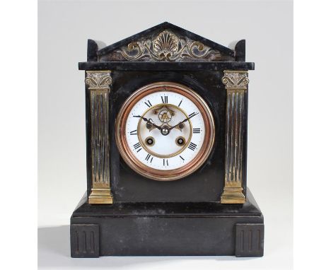 Victorian black slate and brass mantel clock. The arched top above brass reeded columns, the white enamel dial with show esca