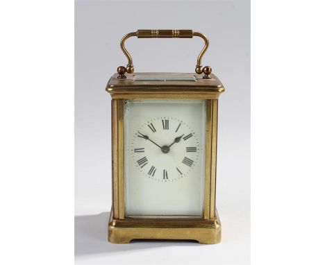 Gilt brass carriage clock with a white enamel dial, bevelled glass, lever platform escapement, 14cm high