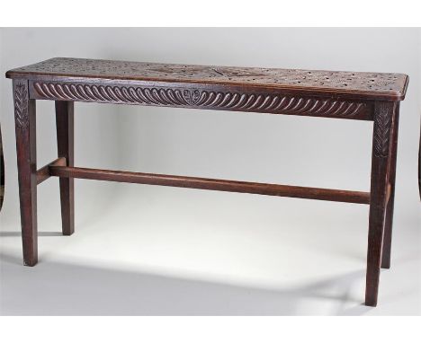 Early 20th Century oak bench, with a carved rectangular top above tapering legs