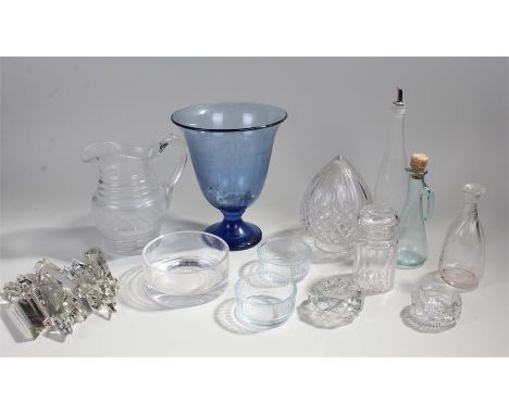 A mixed lot of glass wear to include, bottles, a jug, a blue tinted bell shaped vase, a jar, ash trays, cut glass lamp shade,