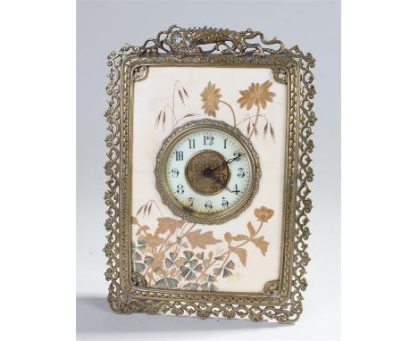 19th Century porcelain and brass easel clock, the porcelain front with gilt leaf decoration, the brass frame surmounted by a 