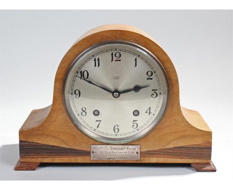 A 1930's mantel clock with silvered dial and Arabic numerals contained in a bleached mahogany Admirals hat shaped case with e