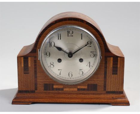 Early 20th Century oak cased mantel clock, the arched top above a silvered dial and Arabic hours