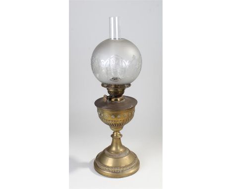 Brass oil lamp, the frosted glass shade above a glass chimney and gadrooned brass body