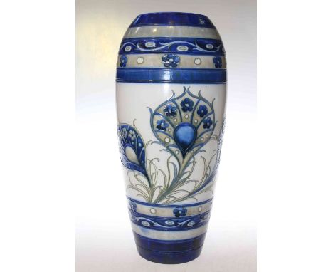 William Moorcroft (1872-1945), a 1930's salt glazed vase, of ovoid form, tubelined and hand painted with peacock feathers, bl