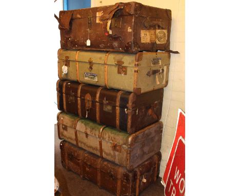 Five vintage canvas bound travelling trunks