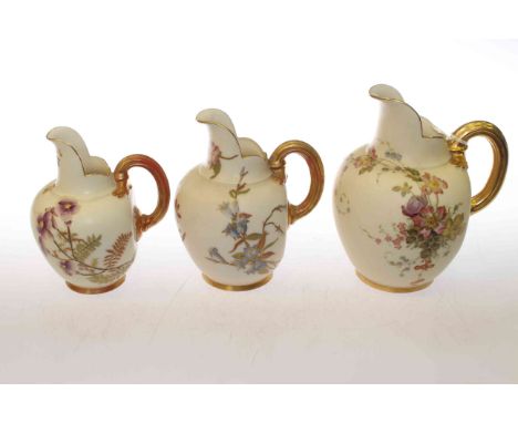 Three Royal Worcester graduated flat-back jugs, tallest 15.5cm